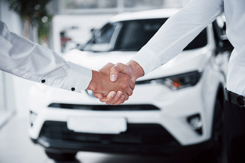 close-up-sales-manager-black-suit-selling-car-customer