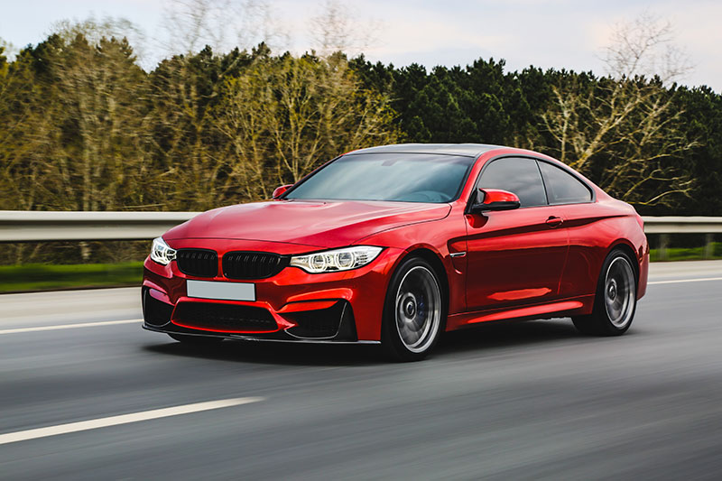 red-luxury-sedan-road